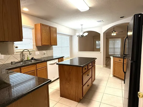 a kitchen with stainless steel appliances granite countertop a sink and a stove