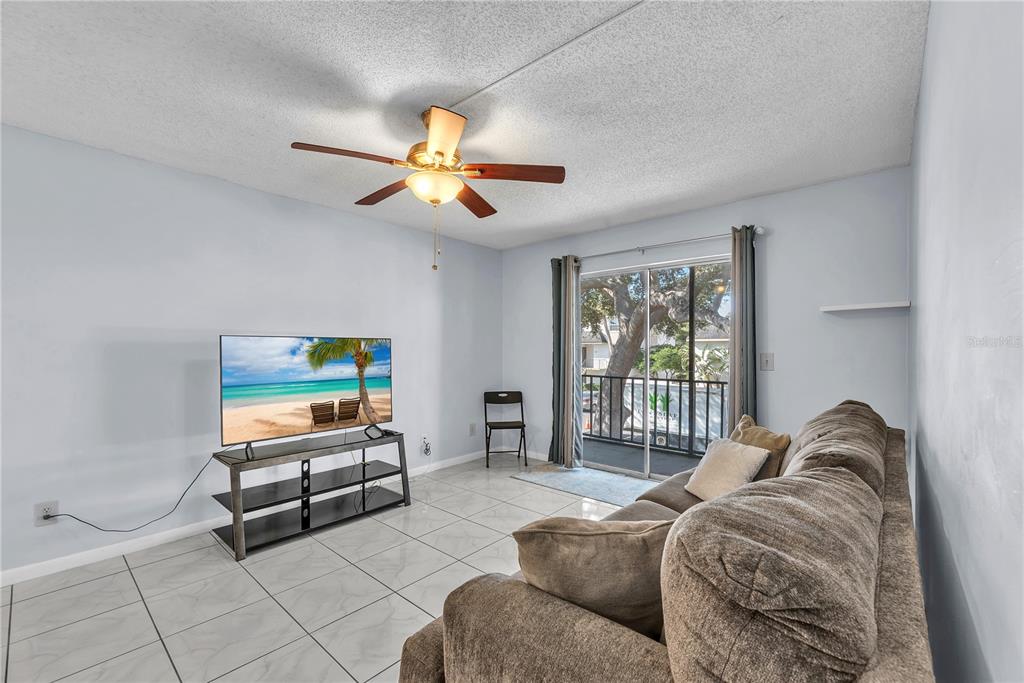 801 Russell Lane, Unit 255 Brandon, FL 33510 - Photo 13 of 22 a living room with furniture a ceiling fan and a window