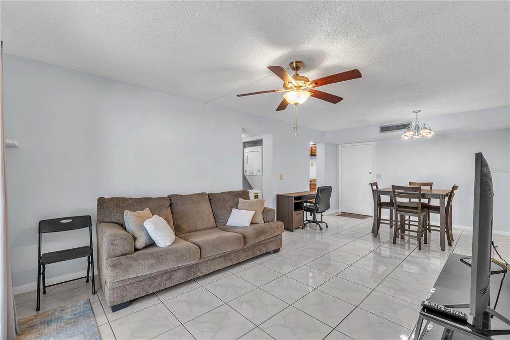 801 Russell Lane, Unit 255 Brandon, FL 33510 - Photo 15 of 22 a living room with furniture a dining table and a ceiling fan