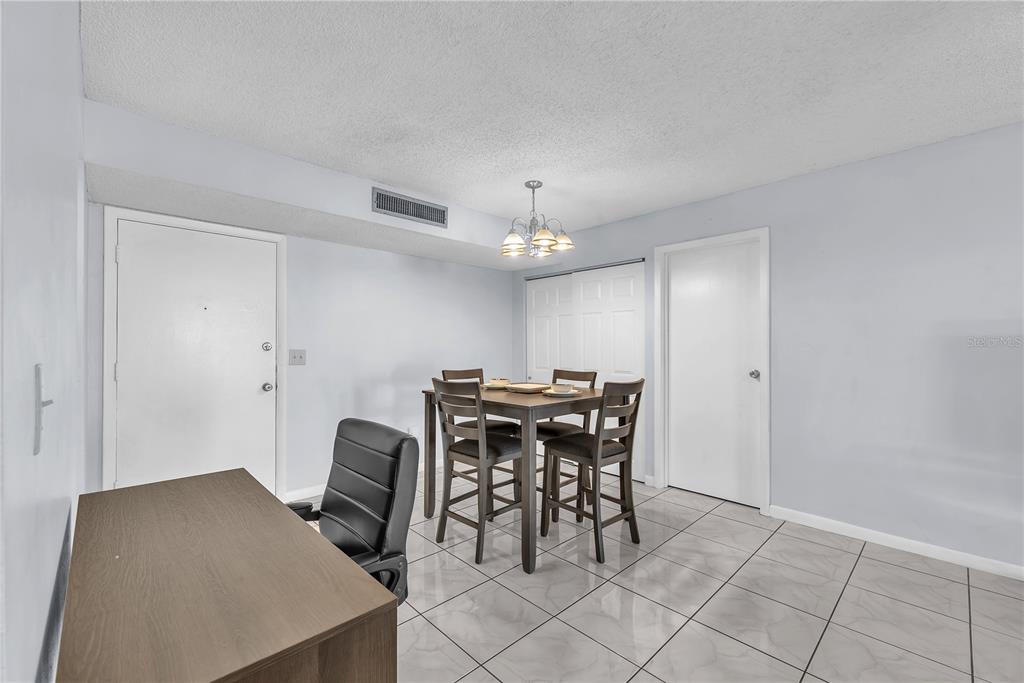 801 Russell Lane, Unit 255 Brandon, FL 33510 - Photo 16 of 22 a view of a dining room with furniture and chandelier