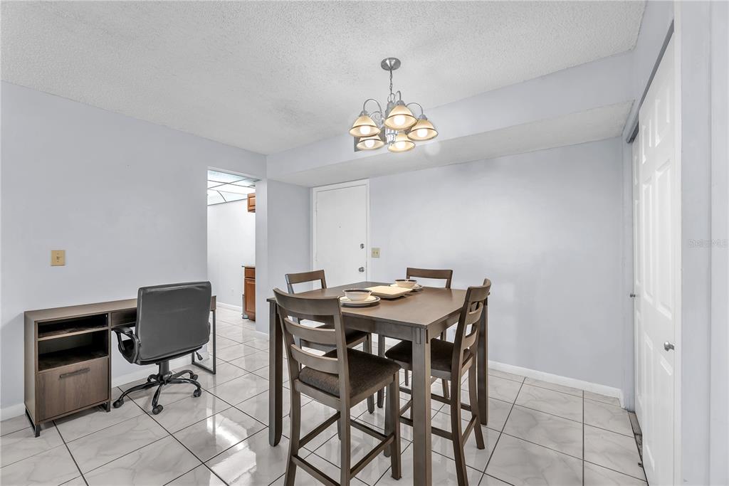 801 Russell Lane, Unit 255 Brandon, FL 33510 - Photo 17 of 22 a view of a dining room with furniture and chandelier