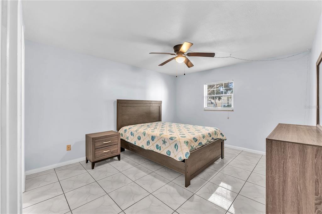 801 Russell Lane, Unit 255 Brandon, FL 33510 - Photo 4 of 22 a bedroom with a large bed and a chandelier