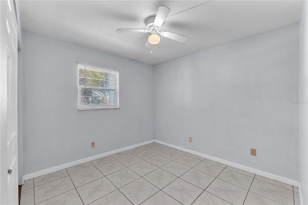 801 Russell Lane, Unit 255 Brandon, FL 33510 - Photo 6 of 22 an empty room with a window and a fan