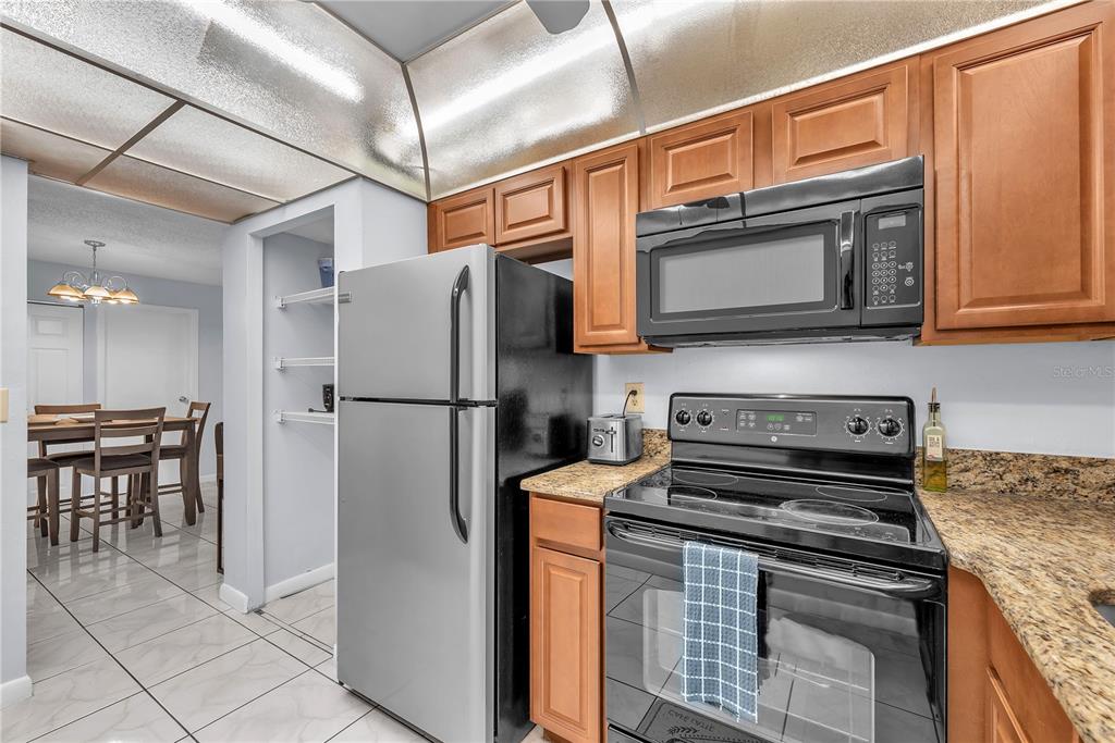 801 Russell Lane, Unit 255 Brandon, FL 33510 - Photo 9 of 22 a kitchen with stainless steel appliances granite countertop a stove microwave and refrigerator