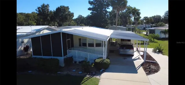 a view of house with backyard outdoor seating and green space