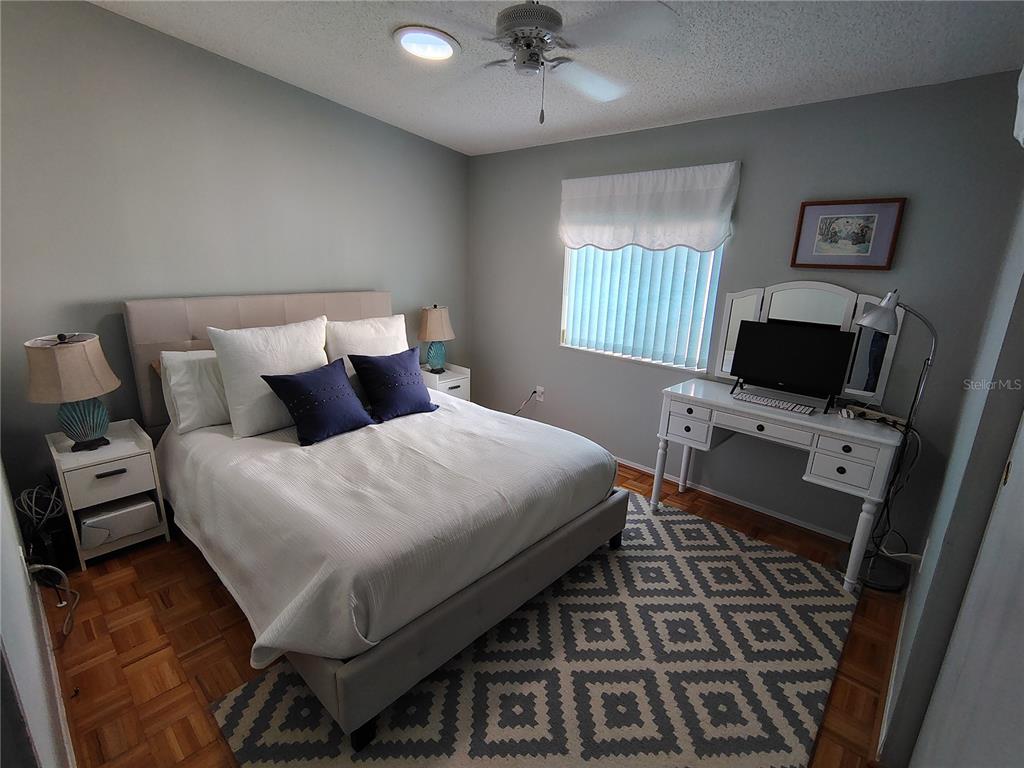 116 Lyonia Lane Wildwood, FL 34785 - Photo 20 of 37 a bedroom with a bed and a flat screen tv