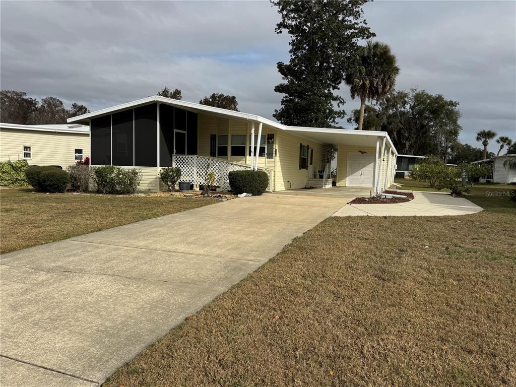 116 Lyonia Lane Wildwood, FL 34785 - Photo 2 of 37 a view of a house with backyard porch and sitting area
