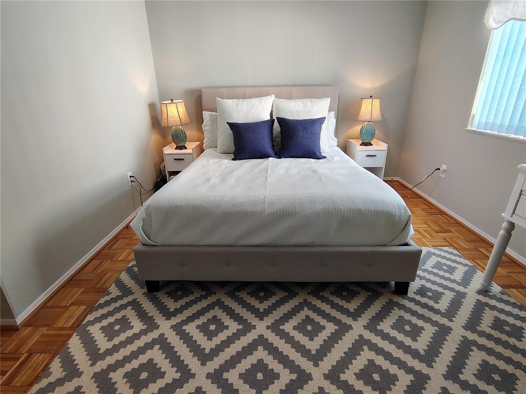 116 Lyonia Lane Wildwood, FL 34785 - Photo 21 of 37 a bed sitting in a bedroom next to a window