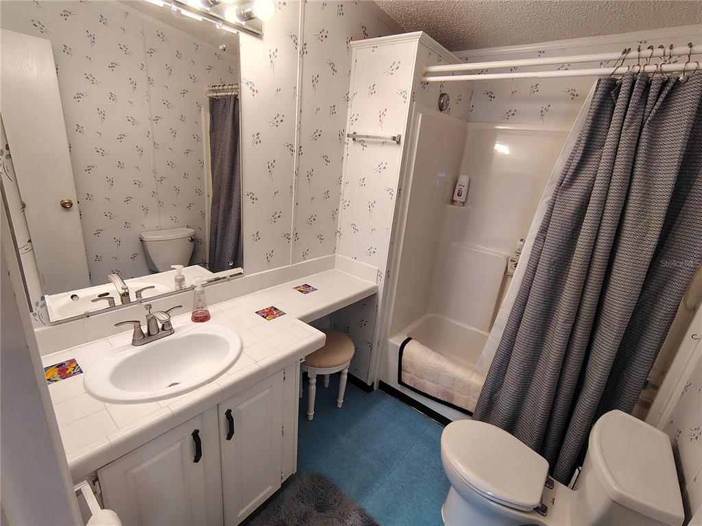 116 Lyonia Lane Wildwood, FL 34785 - Photo 23 of 37 a bathroom with a sink toilet and shower