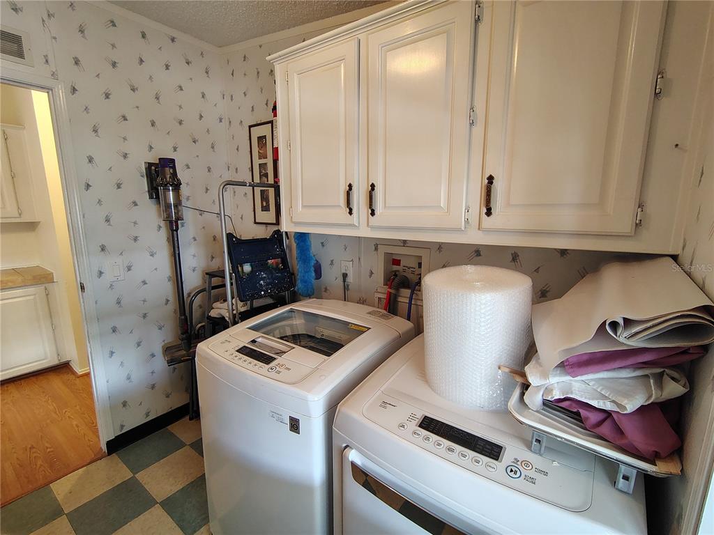116 Lyonia Lane Wildwood, FL 34785 - Photo 31 of 37 a kitchen with a stove and a cabinet