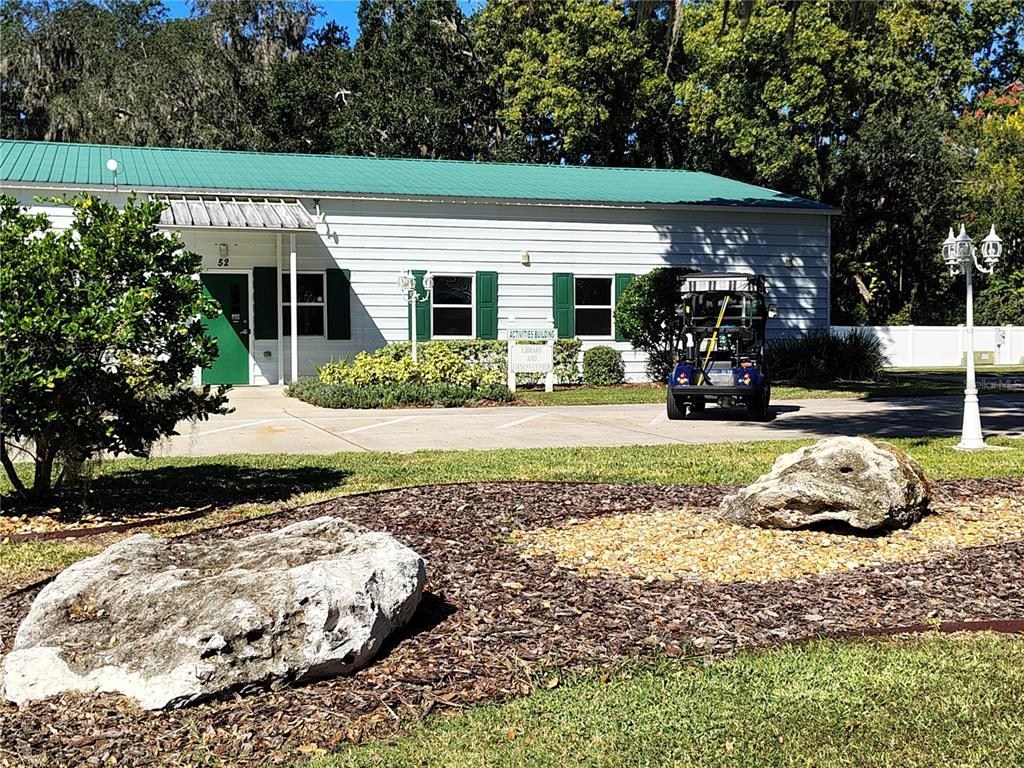 116 Lyonia Lane Wildwood, FL 34785 - Photo 36 of 37 a view of a house with backyard outdoor space and garden