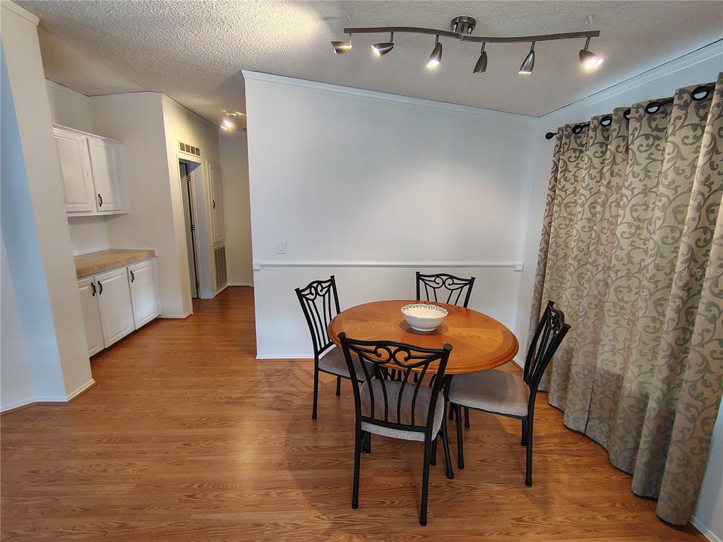 116 Lyonia Lane Wildwood, FL 34785 - Photo 8 of 37 a view of a dining room with furniture and wooden floor