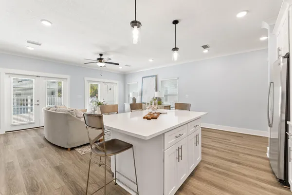 a view of kitchen island with sink and refrigerator