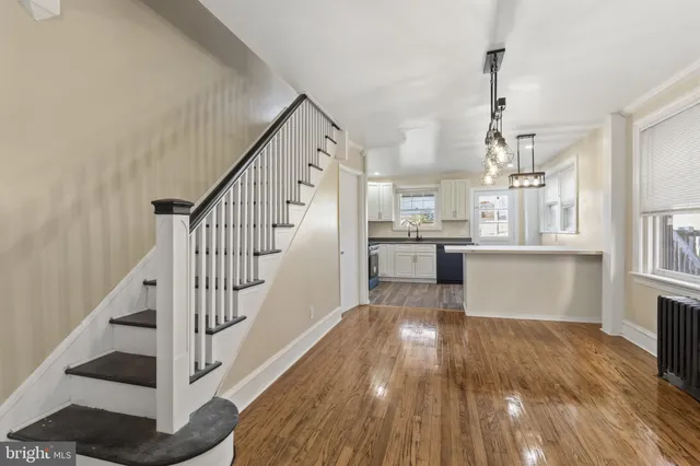 a view of a kitchen with wooden floor and electronic appliances