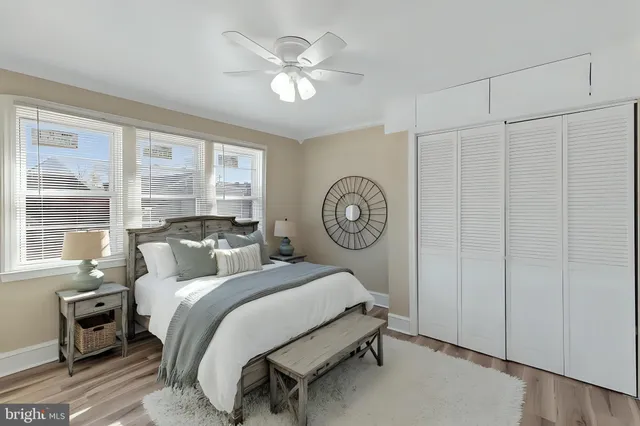 a bedroom with a bed and a large window