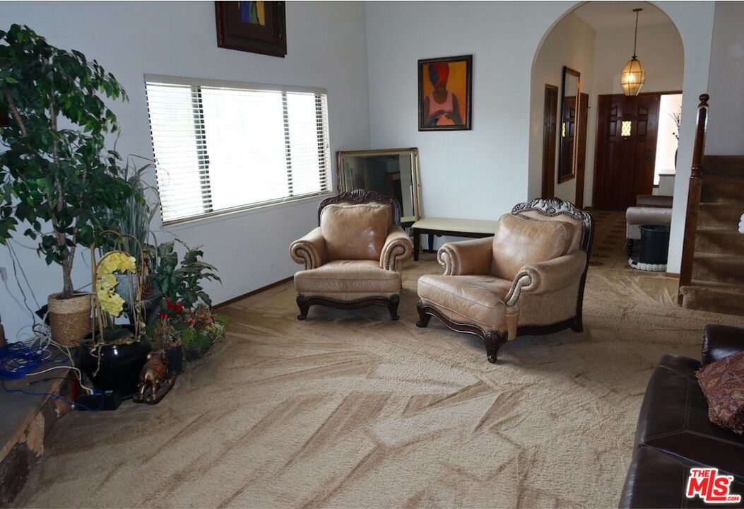 13330 Tamarisk Road Victorville, CA 92395 - Photo 11 of 33 a living room with furniture and a flat screen tv