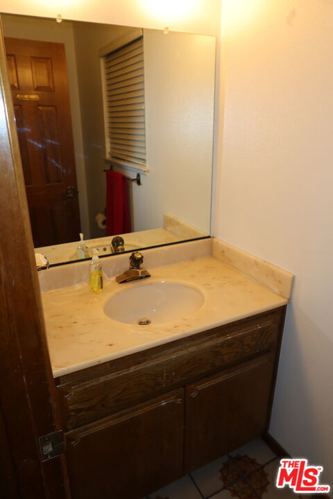 13330 Tamarisk Road Victorville, CA 92395 - Photo 13 of 33 a bathroom with a sink and a mirror