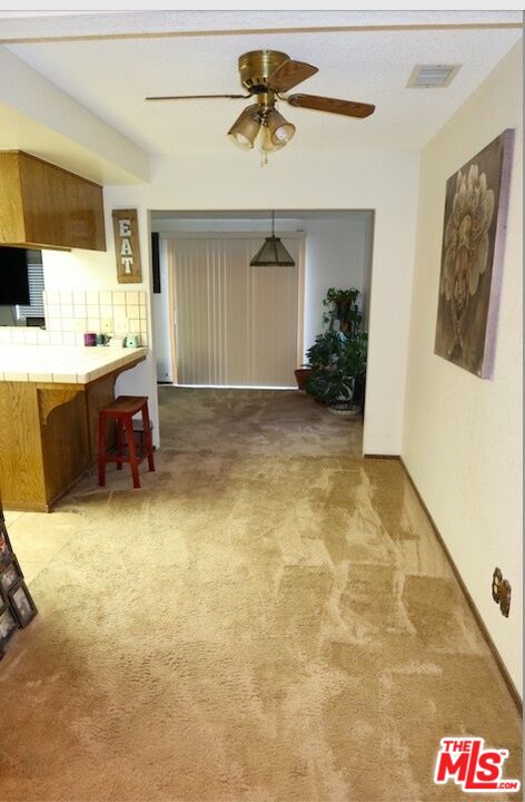 13330 Tamarisk Road Victorville, CA 92395 - Photo 20 of 33 a view of a livingroom with furniture and a ceiling fan