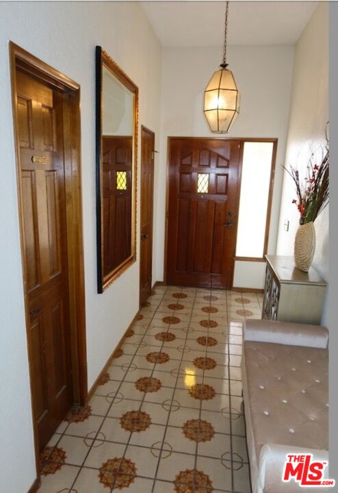 13330 Tamarisk Road Victorville, CA 92395 - Photo 22 of 33 a view of a hallway with wooden floor mirror and windows