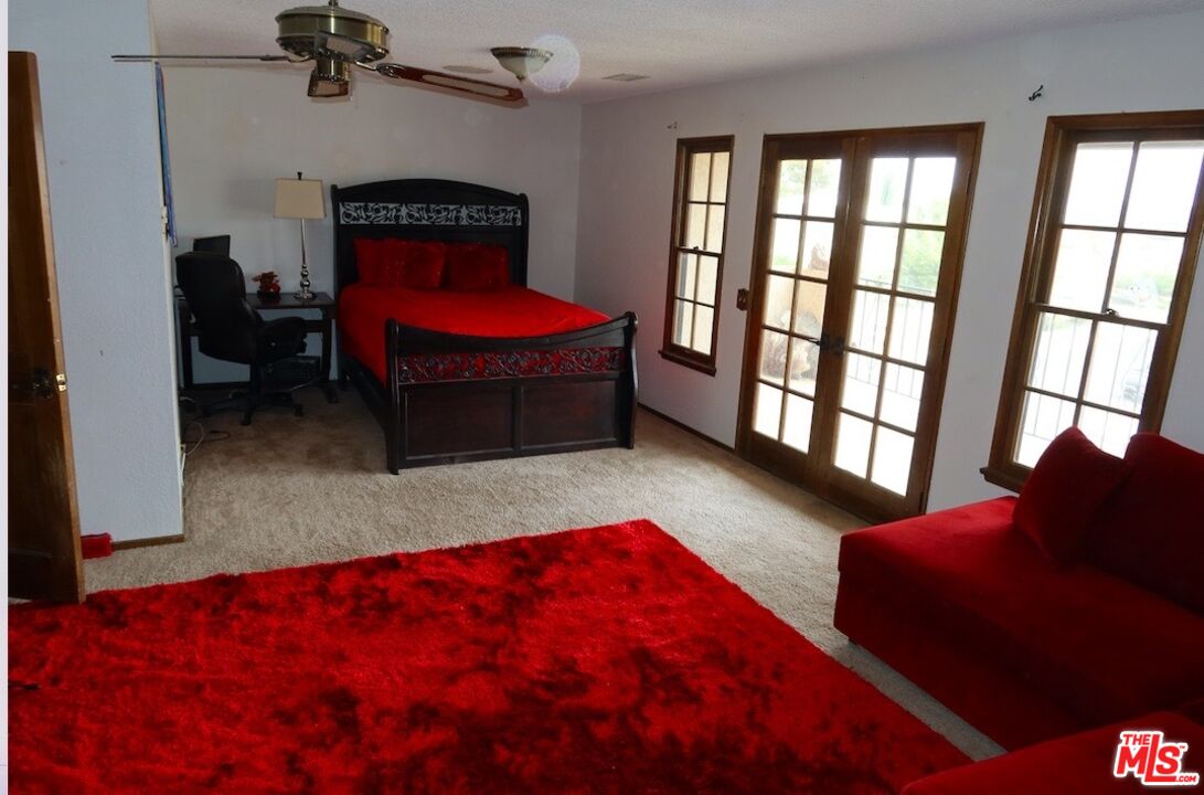 13330 Tamarisk Road Victorville, CA 92395 - Photo 23 of 33 a bedroom with a bed and a window