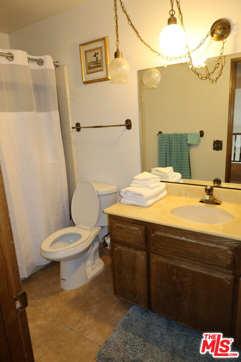 13330 Tamarisk Road Victorville, CA 92395 - Photo 27 of 33 a bathroom with a sink a toilet and shower