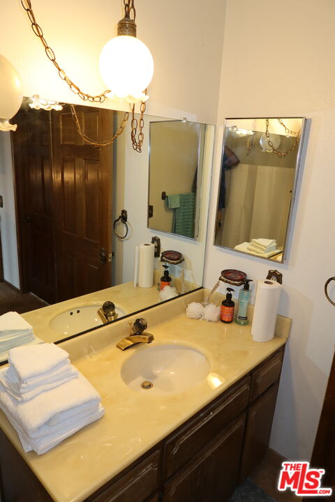 13330 Tamarisk Road Victorville, CA 92395 - Photo 28 of 33 a bathroom with a sink and a mirror