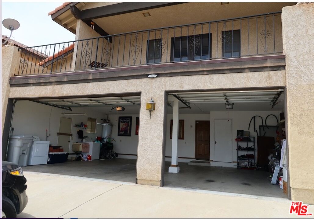 13330 Tamarisk Road Victorville, CA 92395 - Photo 5 of 33 a view of a building with car parked in the parking