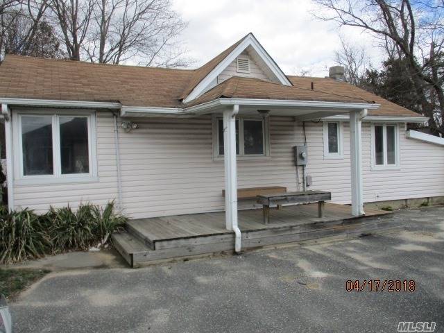 511 Station Road Bellport, NY 11713 - Photo 1 of 1 a view of a house with a yard and garage
