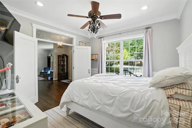 a bedroom with a bed and a chandelier