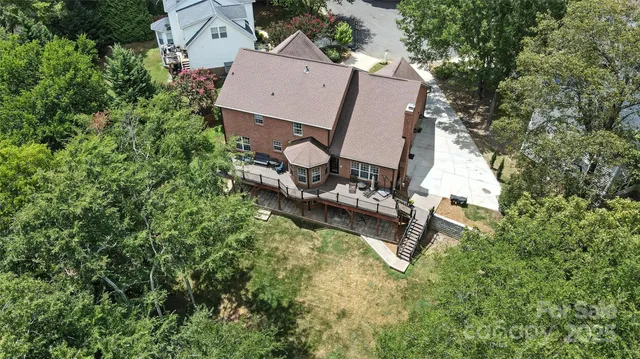an aerial view of a house with swimming pool and garden view