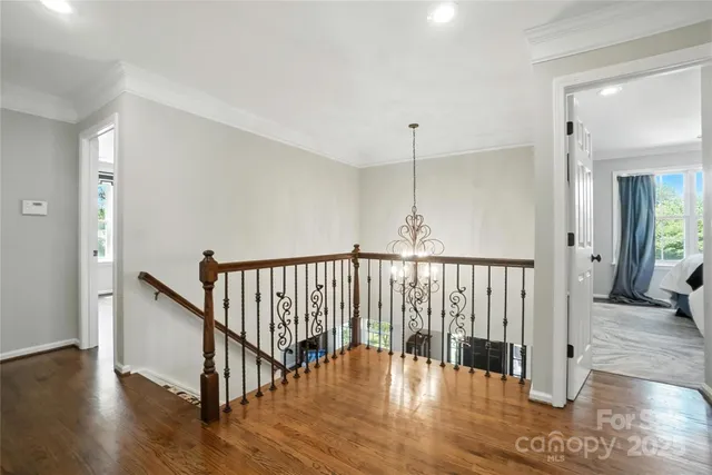 a view of hallway with dining room and wooden floor