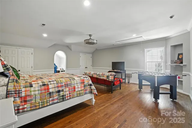 a bedroom with furniture and a wooden floor