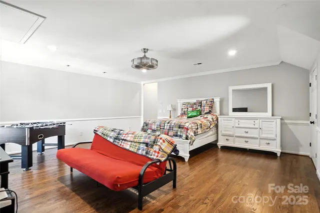 a bedroom with furniture and wooden floor