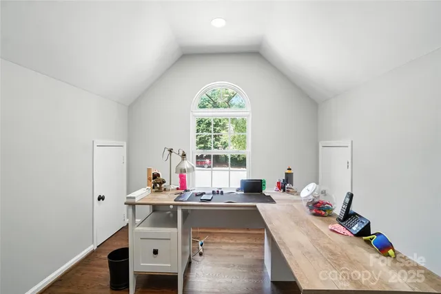a view of a workspace with furniture and window
