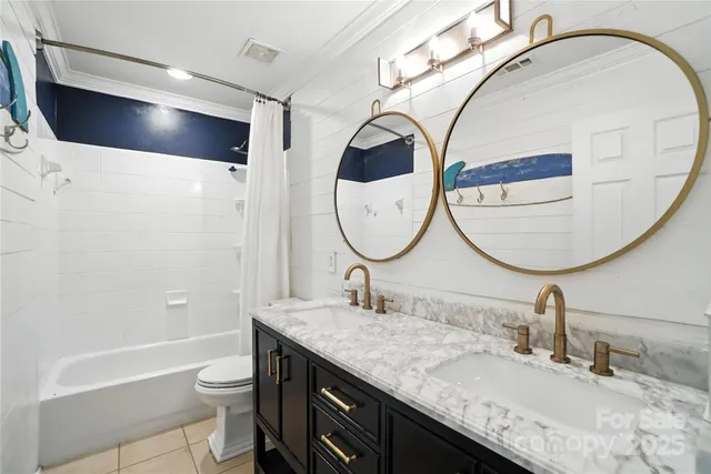 a bathroom with a granite countertop sink a mirror and a toilet