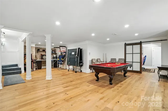 a room with lots of furniture and wooden floors