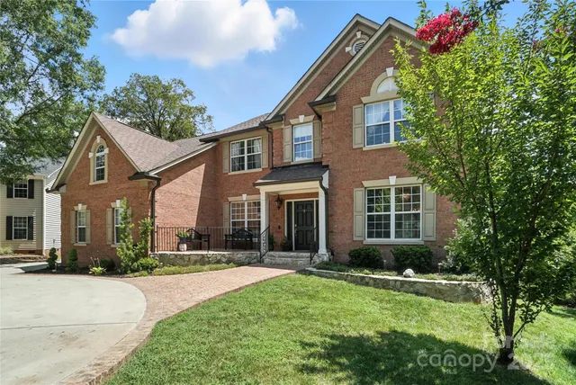 a front view of house with yard and green space