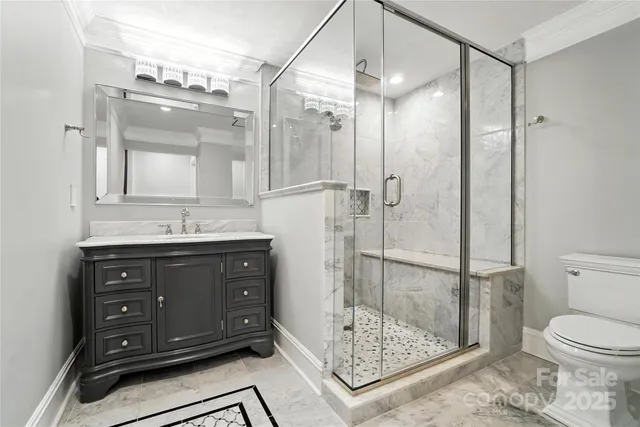 a bathroom with a sink vanity granite and a shower