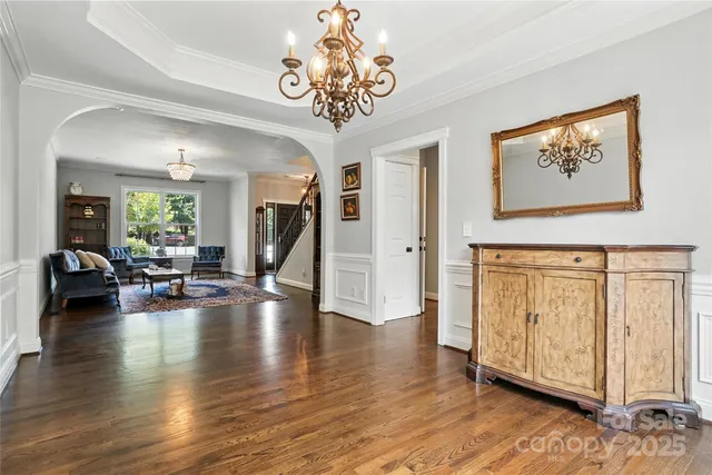 a view of a livingroom with furniture hardwood floor and a ceiling fan
