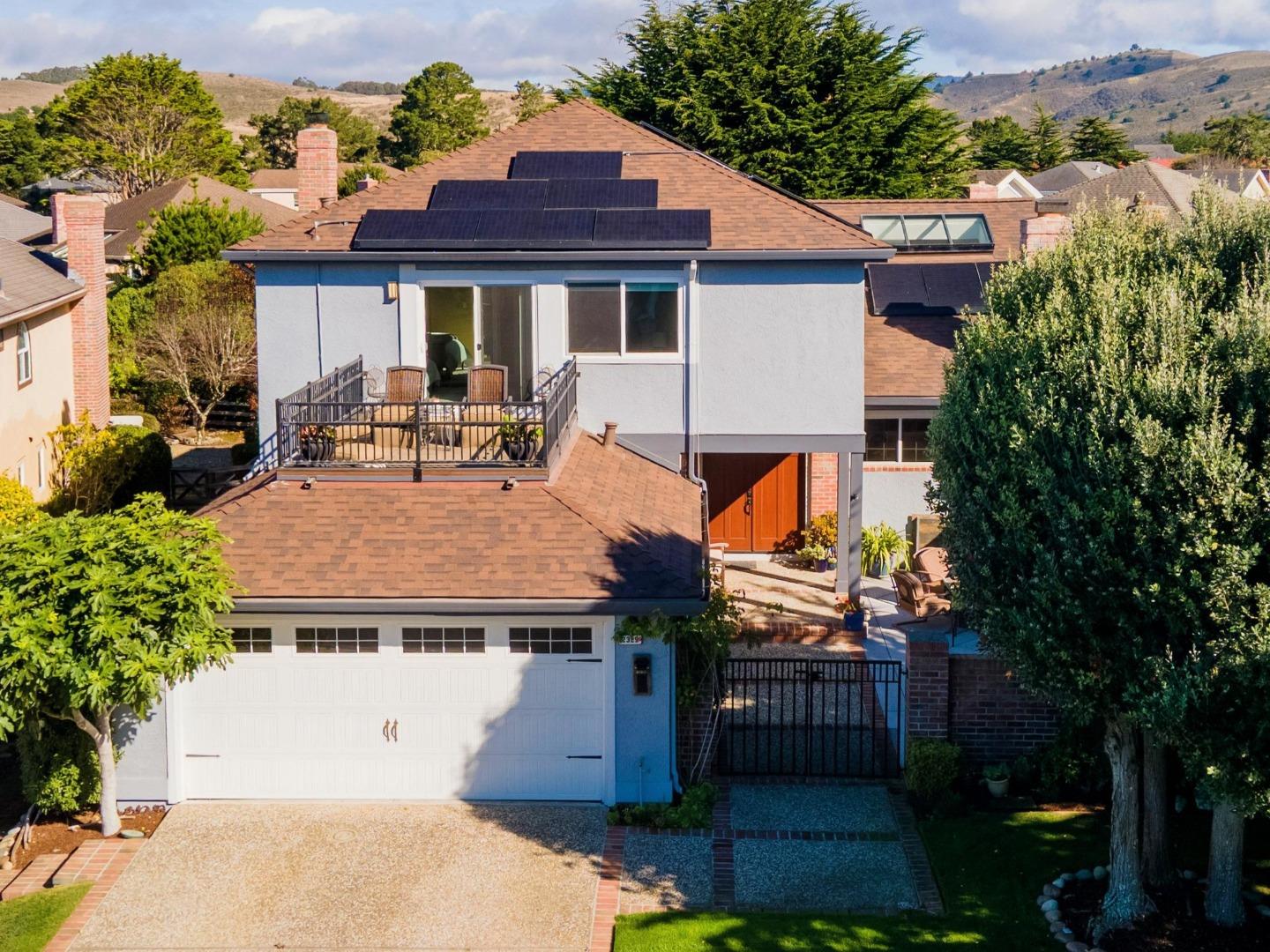 an aerial view of a house with balcony and trees