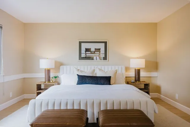 a bedroom with a bed and a lamp