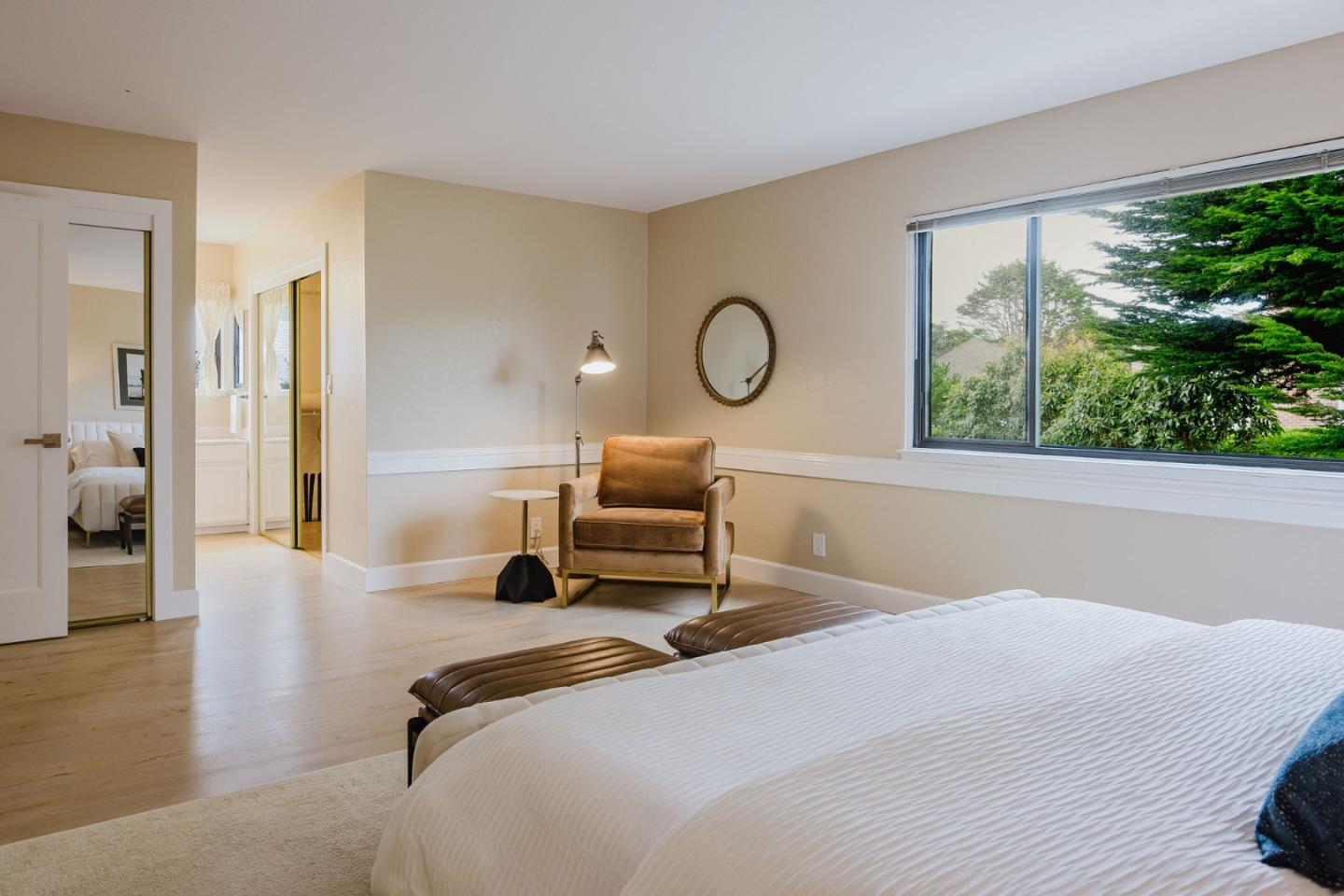 2329 Burning Tree Road Half Moon Bay, CA 94019 - Photo 16 of 35 a bedroom with a bed a large window and wooden floor