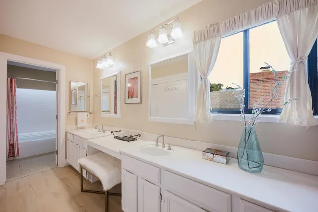 a bathroom with a sink a mirror and a window