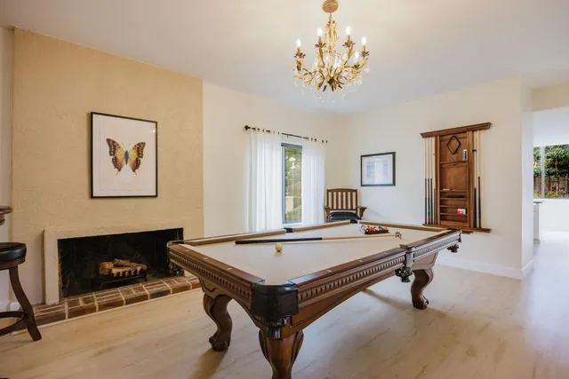 a room with pool table and windows