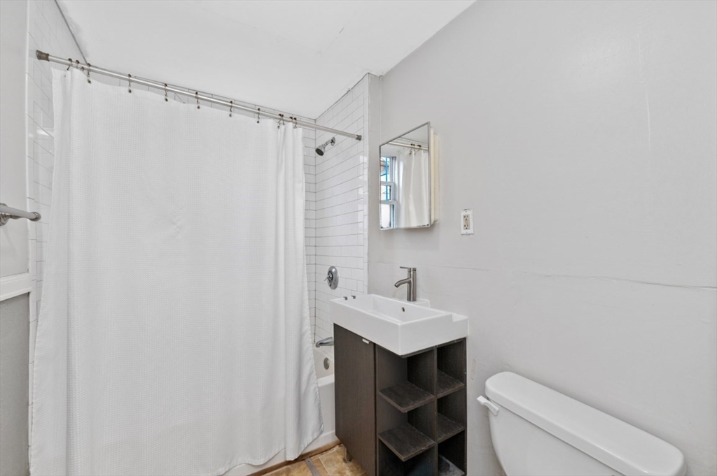19 Dewolf Street Boston, MA 02125 - Photo 14 of 30 a bathroom with a sink toilet and shower