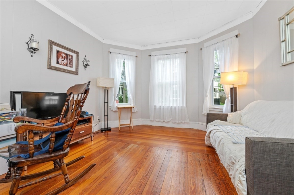 19 Dewolf Street Boston, MA 02125 - Photo 15 of 30 a bedroom with furniture and a window