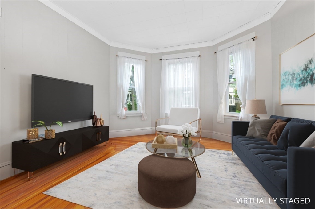 19 Dewolf Street Boston, MA 02125 - Photo 16 of 30 a living room with furniture and a flat screen tv