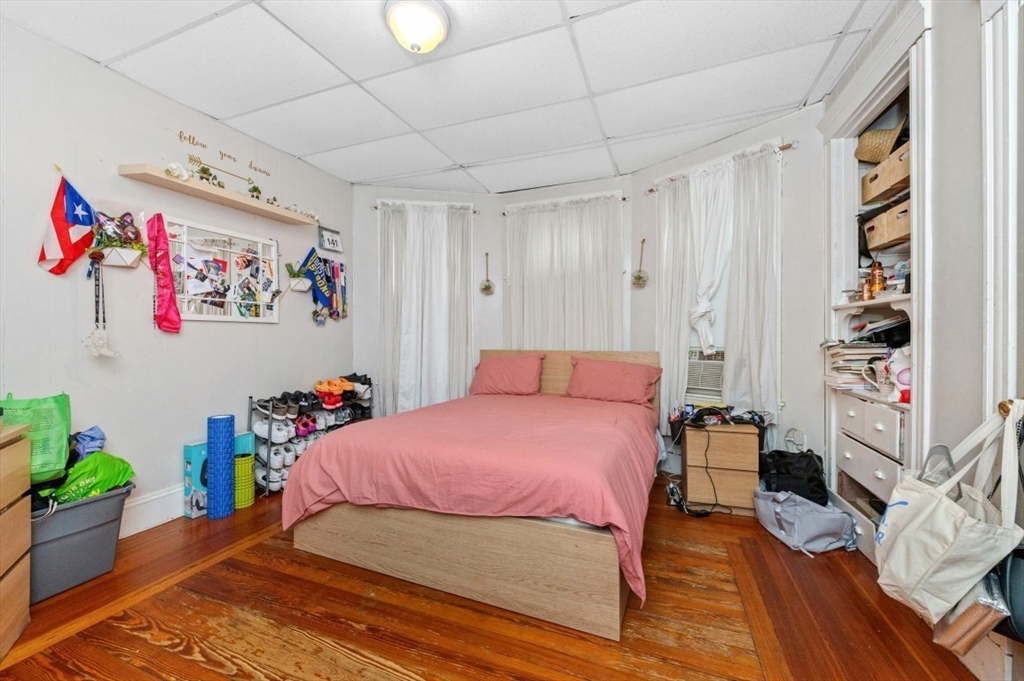 19 Dewolf Street Boston, MA 02125 - Photo 19 of 30 a bedroom with a bed and a book shelf