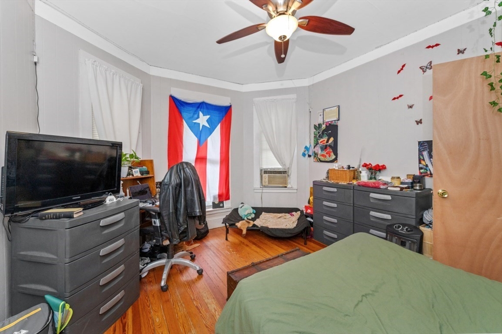 19 Dewolf Street Boston, MA 02125 - Photo 20 of 30 a bedroom with a bed and a flat screen tv