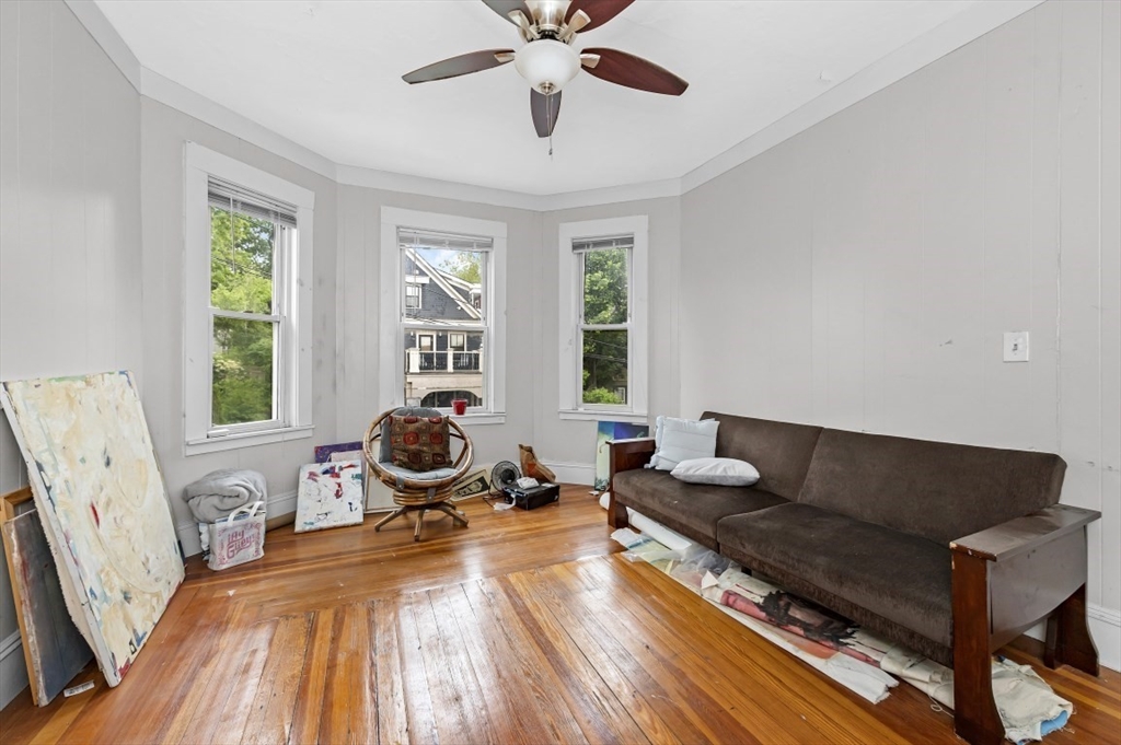 19 Dewolf Street Boston, MA 02125 - Photo 2 of 30 a living room with furniture and a fireplace